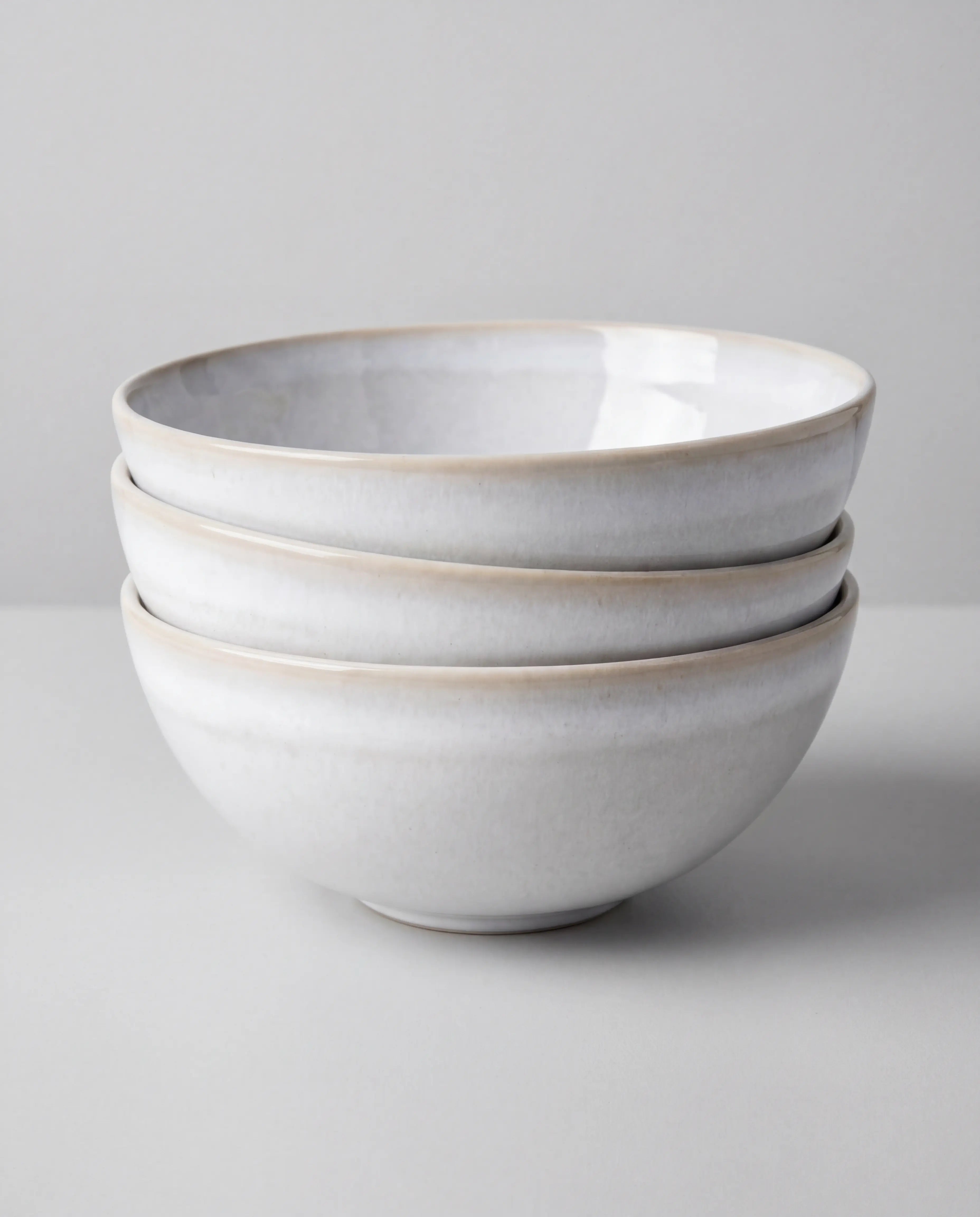 Stack of white ceramic bowls from the Lyra 48 plus 2 piece dish set