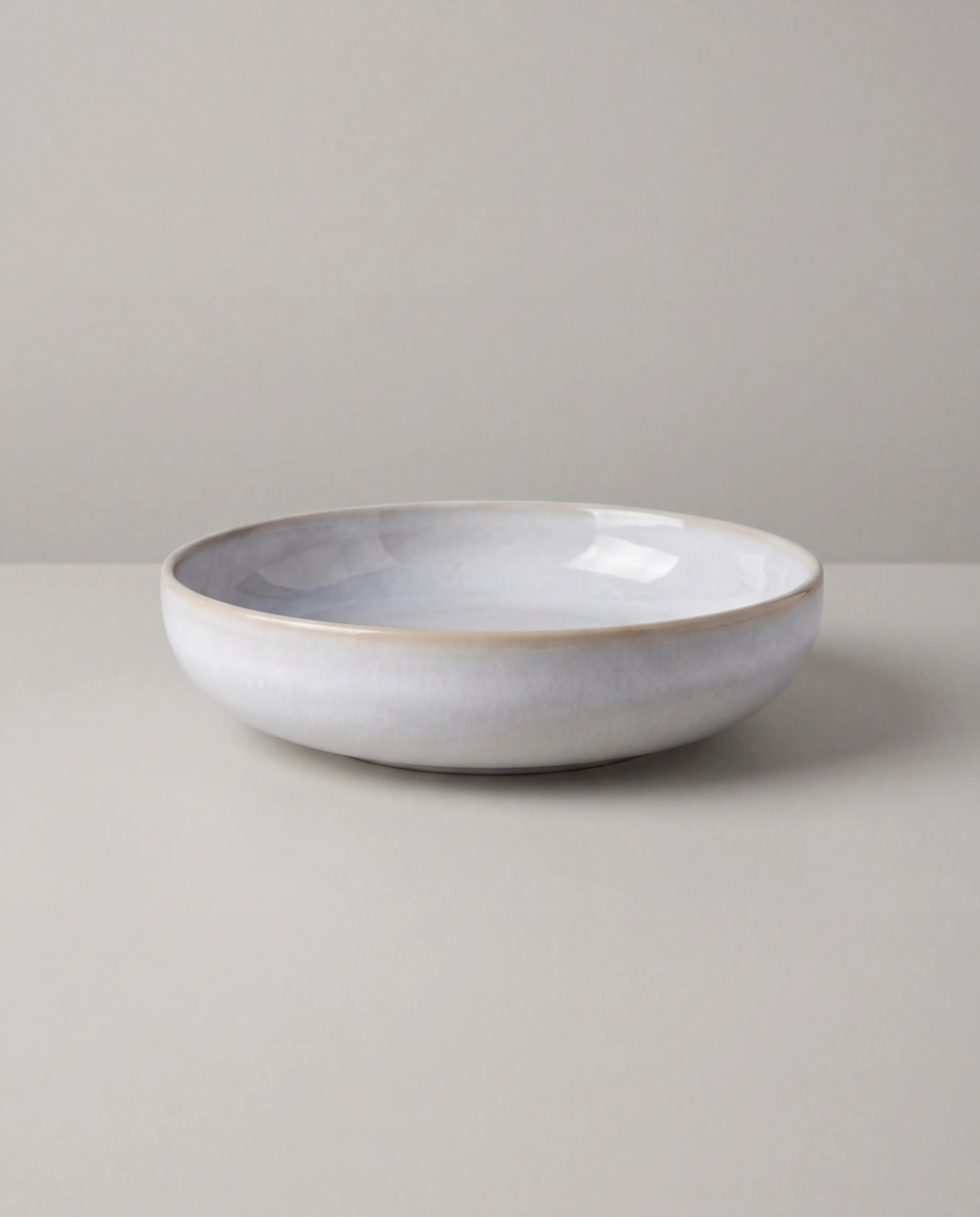 Lyra dinnerware bowl from the 48 plus 2 piece set with lemons on a white surface