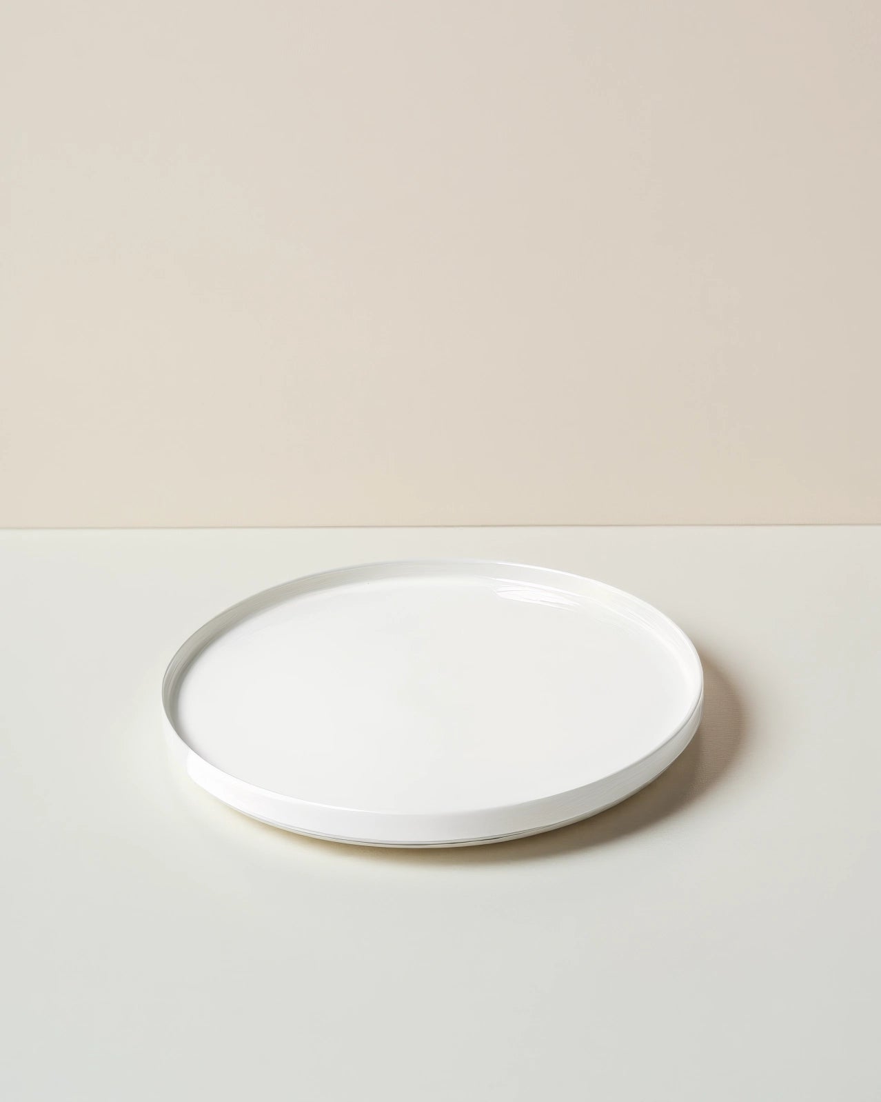 White Vela Alba small plate on a pale backdrop.