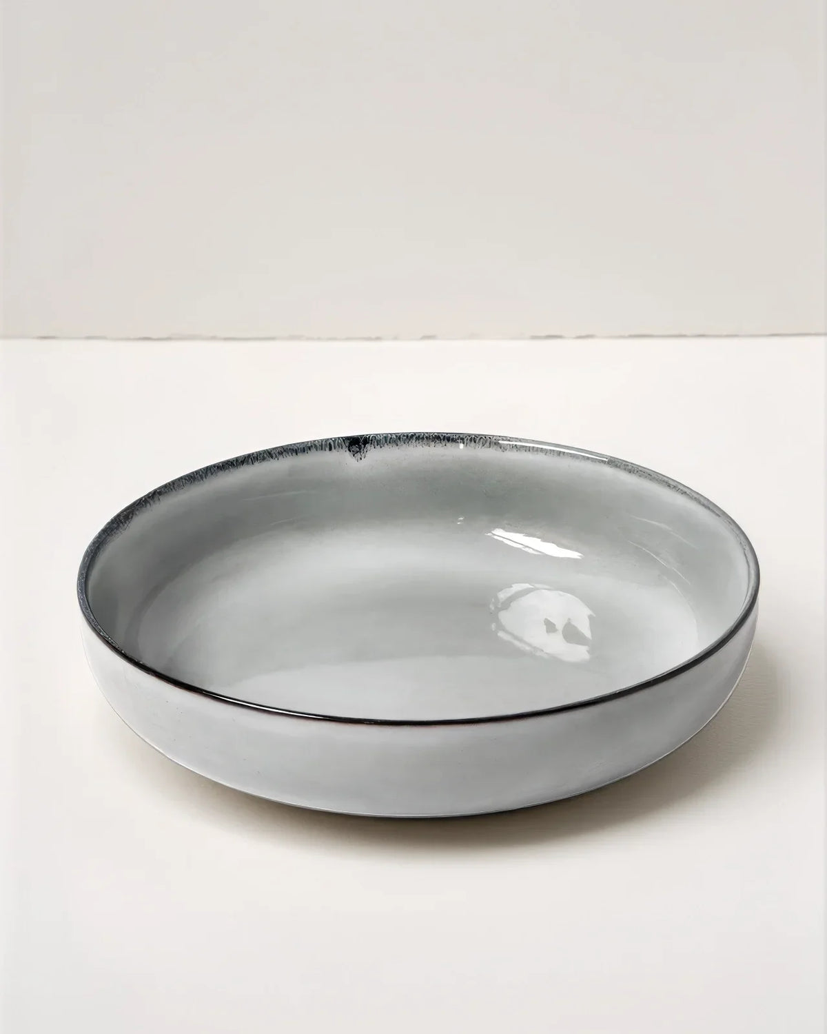 Scandic Soul Nordic Forest serving bowl with pale gray glaze and a dark rim