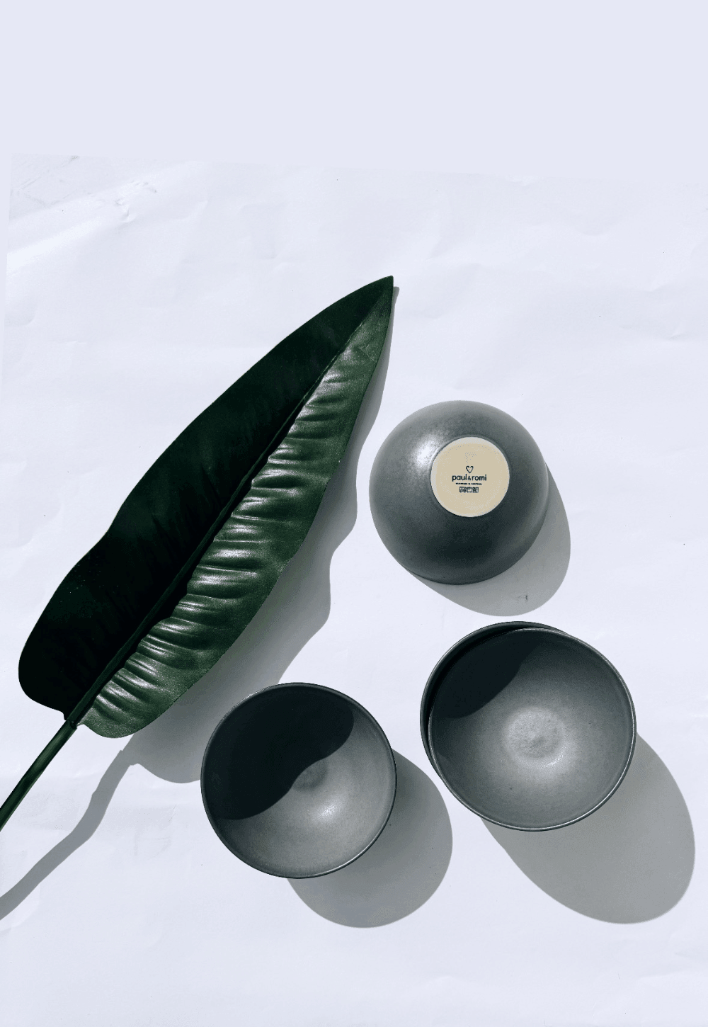 Boa Noite gray ceramic bowls four piece set shown with a leaf on a white background