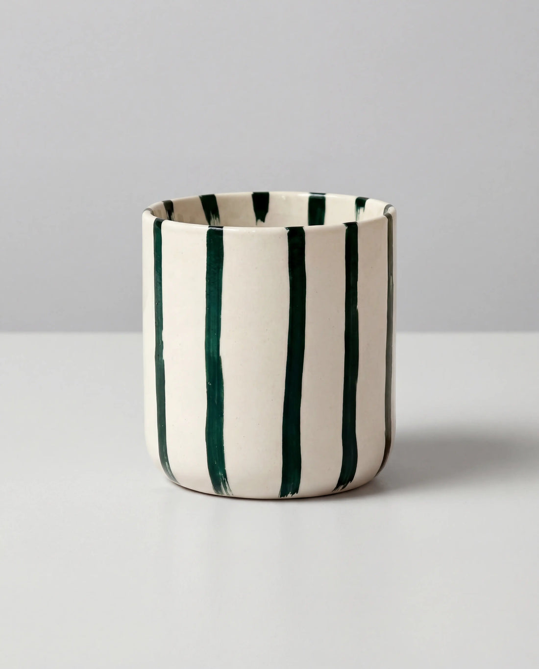 White ceramic Karl mug with bold dark green vertical stripes.