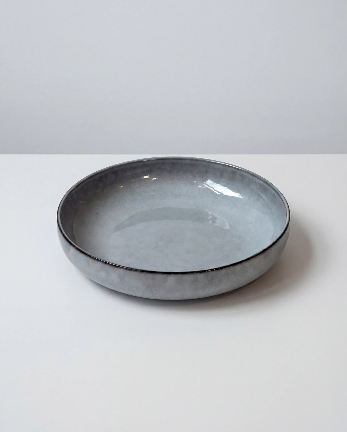 Nordic Fjord pasta plate in gray speckled glaze, edge view