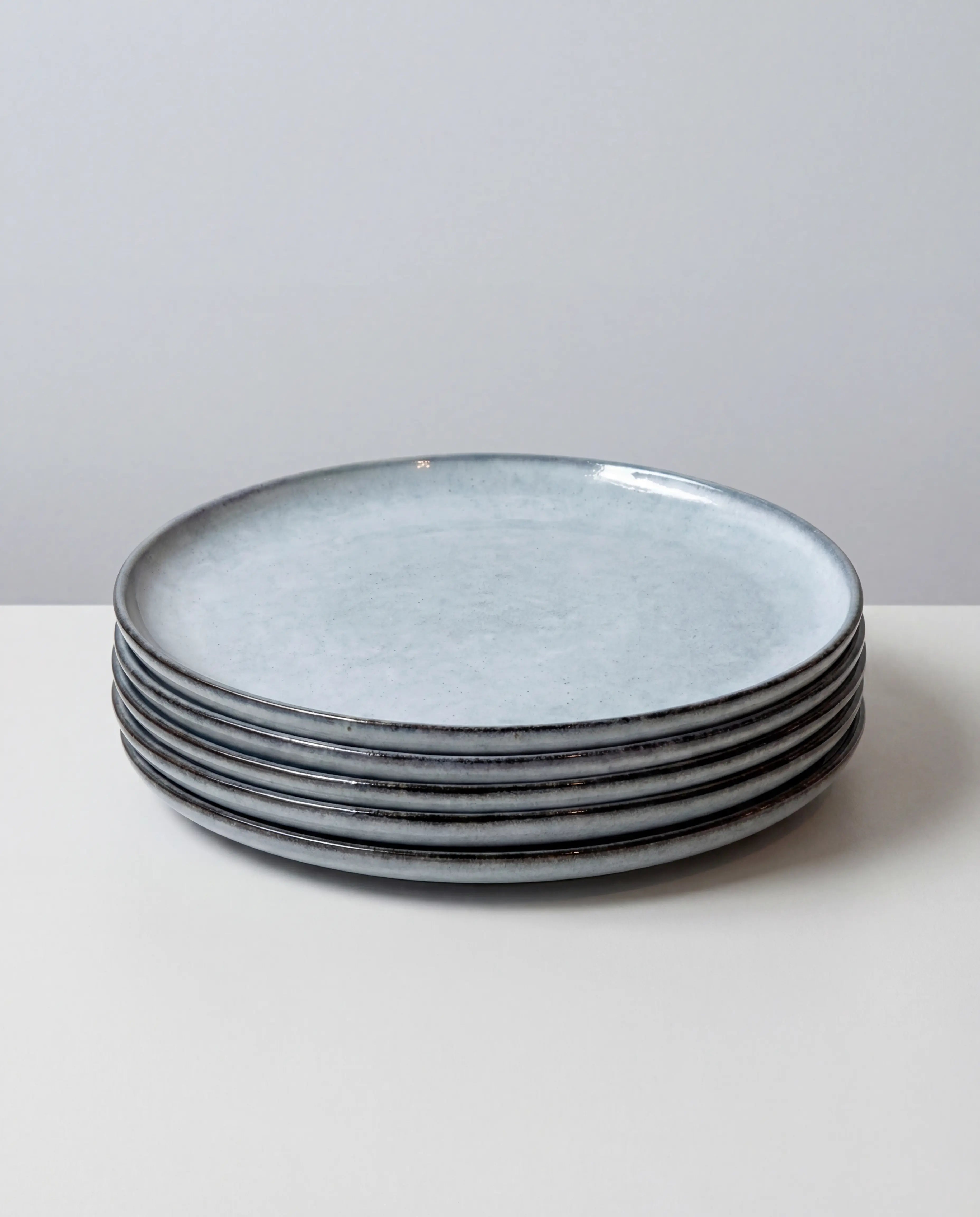 Stack of blue gray Nordic Fjord large plates from the Scandic Soul six piece set