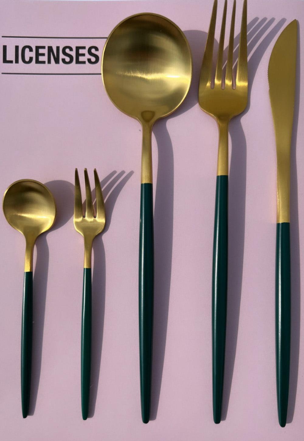 Kophi 30 piece cutlery set on a pink background with gold heads and green handles