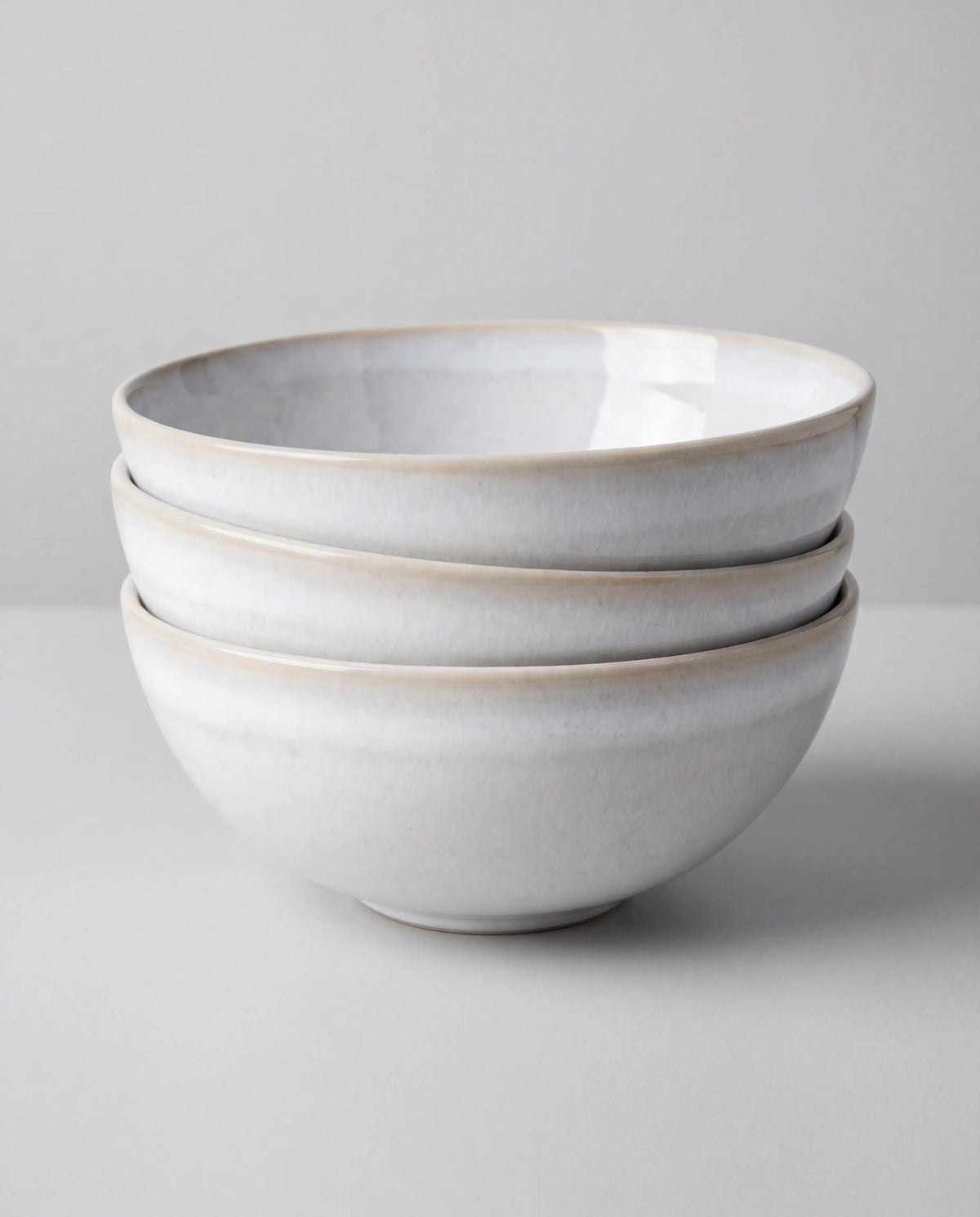 Stack of white ceramic bowls from the Lyra 48 plus 2 piece dish set