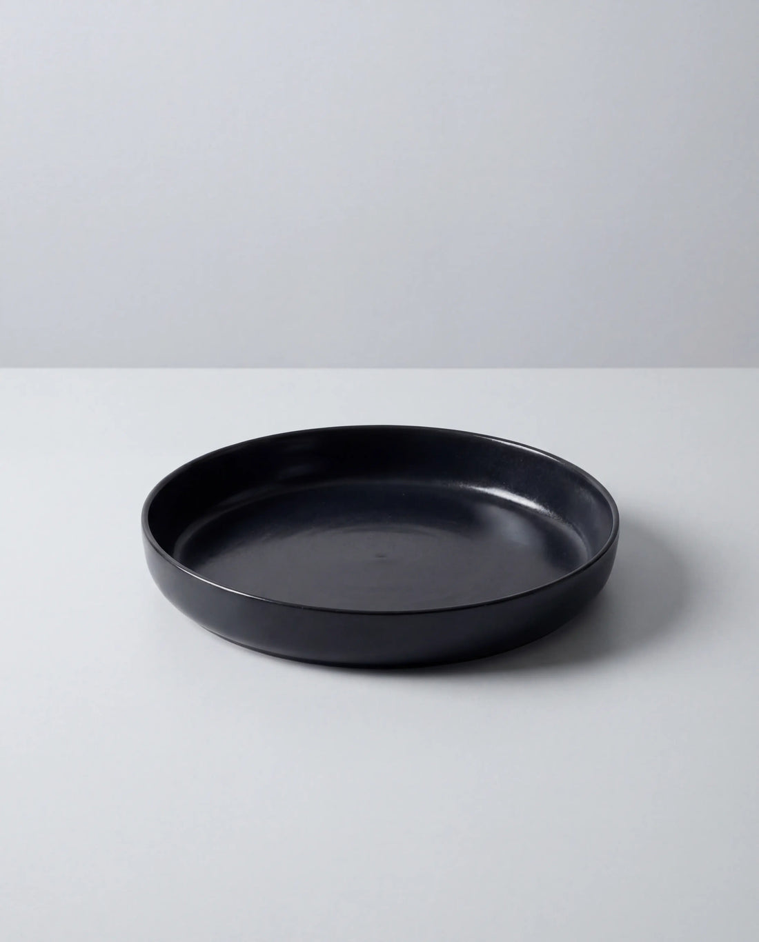Vela Luna Pastateller in matte black partially visible on a white surface