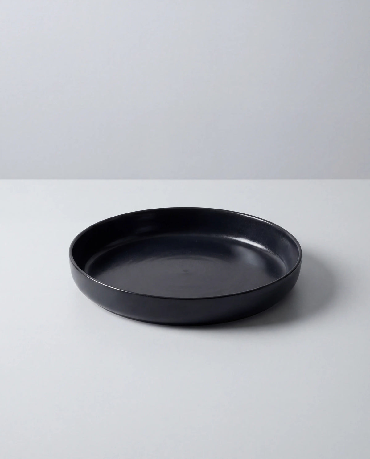 Vela Luna Pastateller in matte black partially visible on a white surface