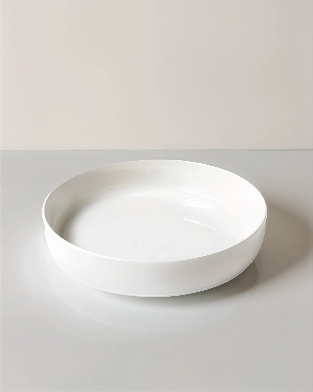 White shallow ceramic bowl from Vela Alba Tilde 48+12 piece dinnerware set.