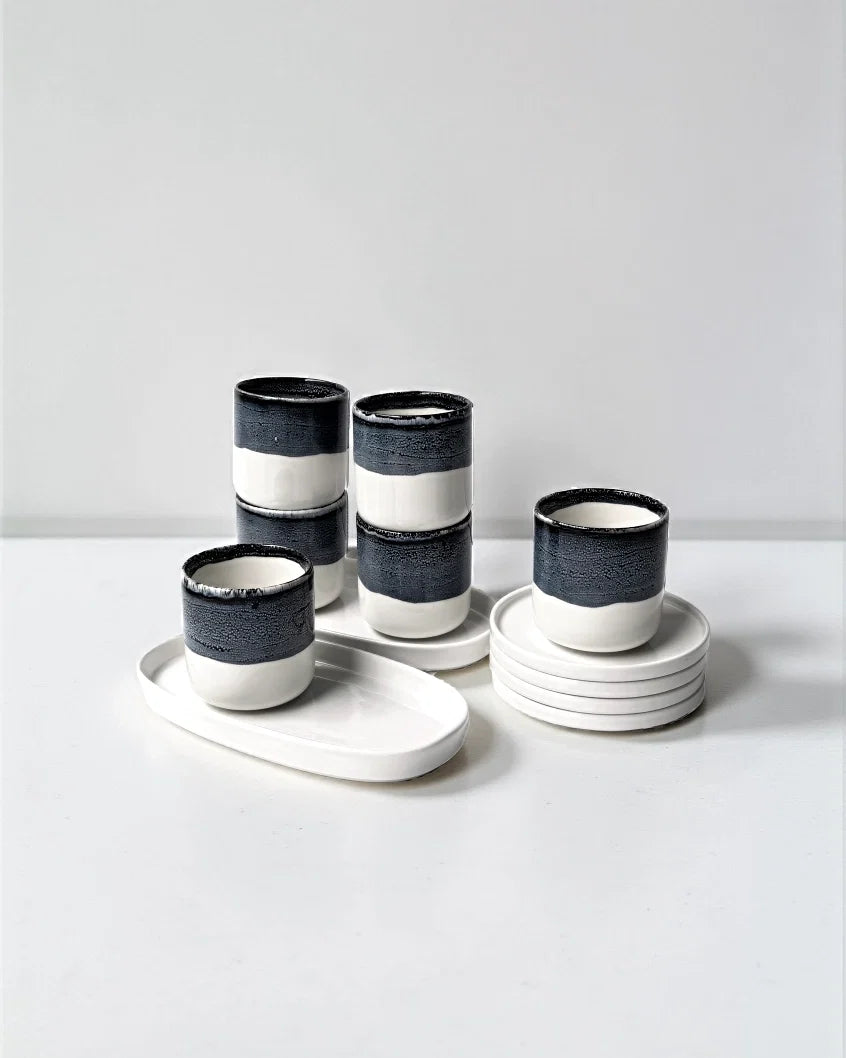 Noa Kaffeemomente 12 piece ceramic coffee set with navy and white two tone cups and matching saucers on a white surface