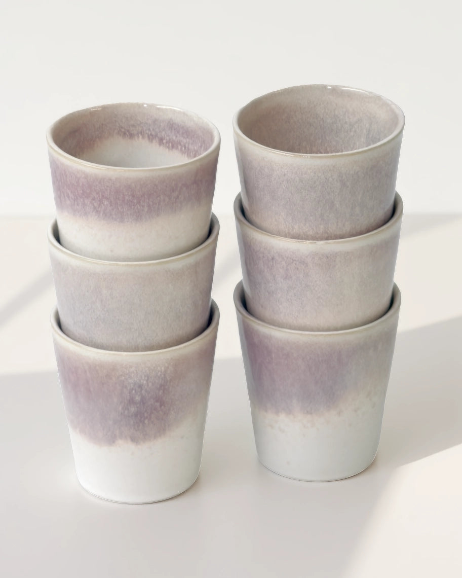 Group of Varadero mugs arranged in two stacks with lavender and white glaze