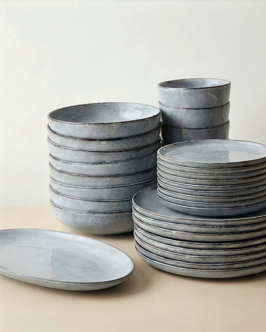 Blue gray Scandic Soul Nordic Fjord dishware stack featuring bowls and plates.